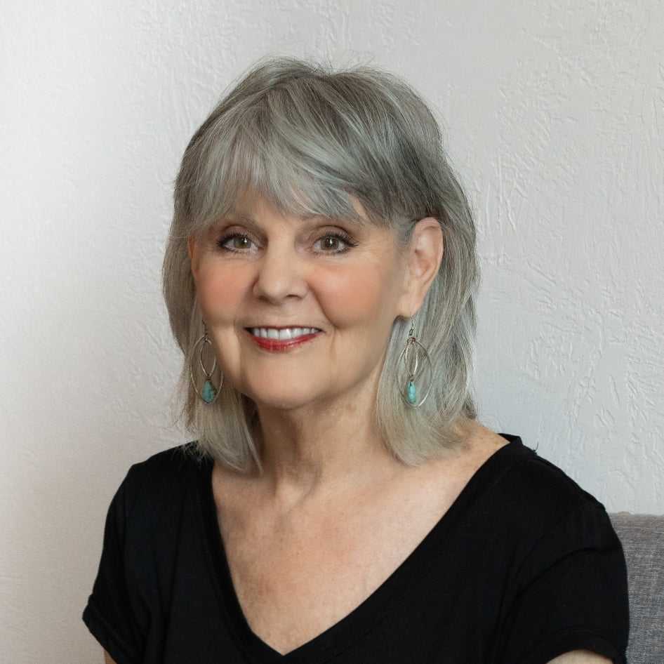 Portrait of Lois, a professional stylist at Above All Grand Salon and Spa, showcasing their expertise and style.