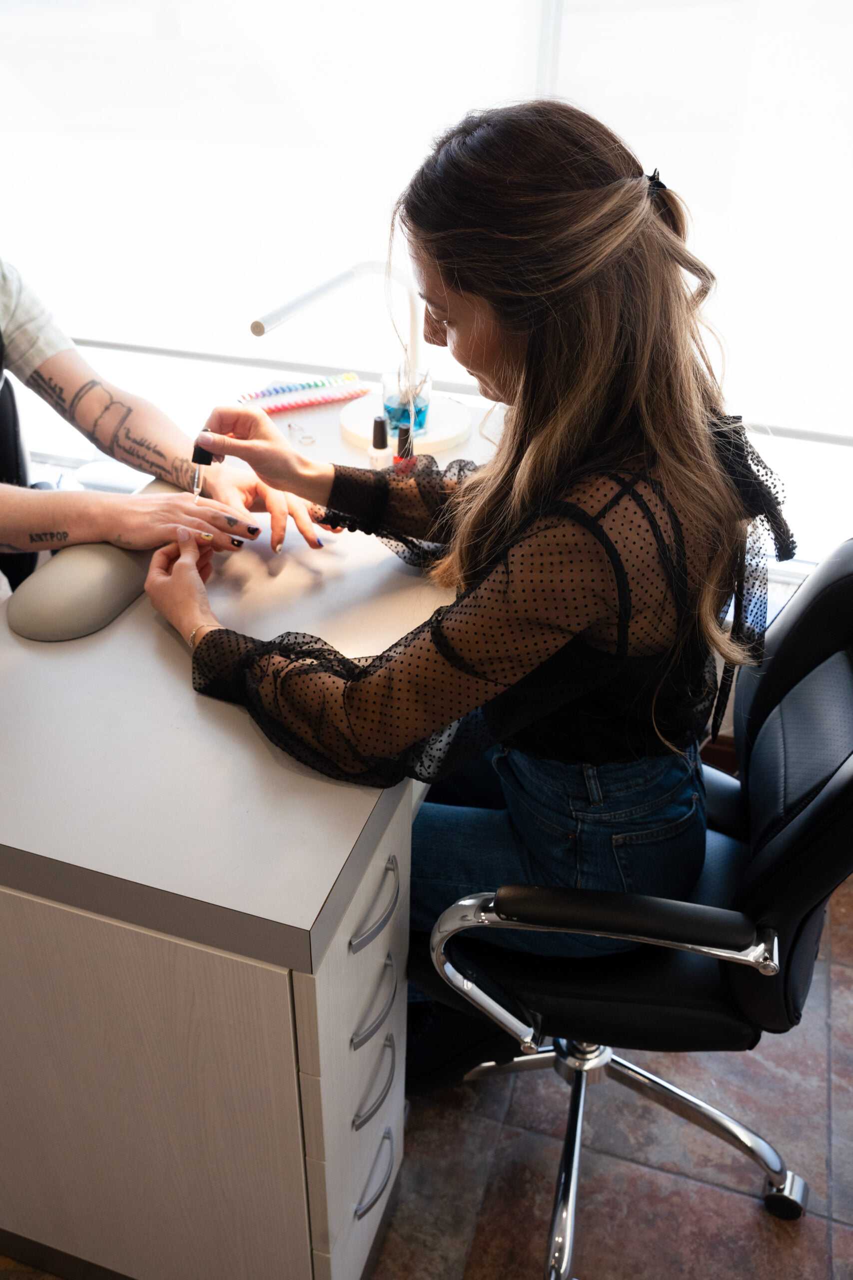 Woman receiving a manicure at a nail salon.