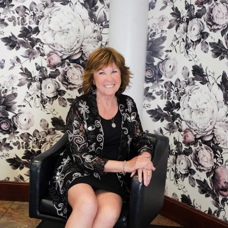 Portrait of Karen, a professional stylist at Above All Grand Salon and Spa, showcasing their expertise and style.