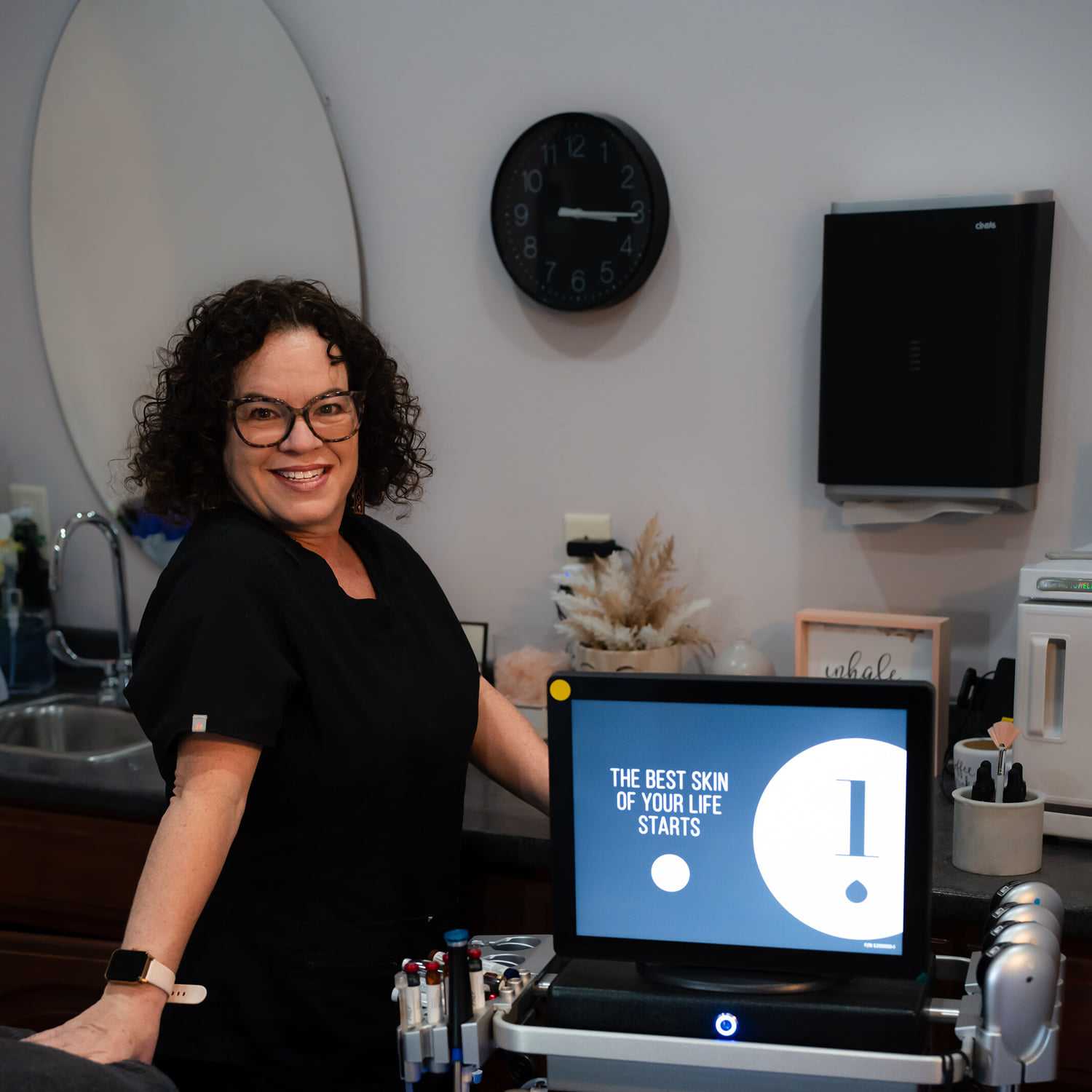 Portrait of Lisa, a professional stylist at Above All Grand Salon and Spa, showcasing their expertise and style.