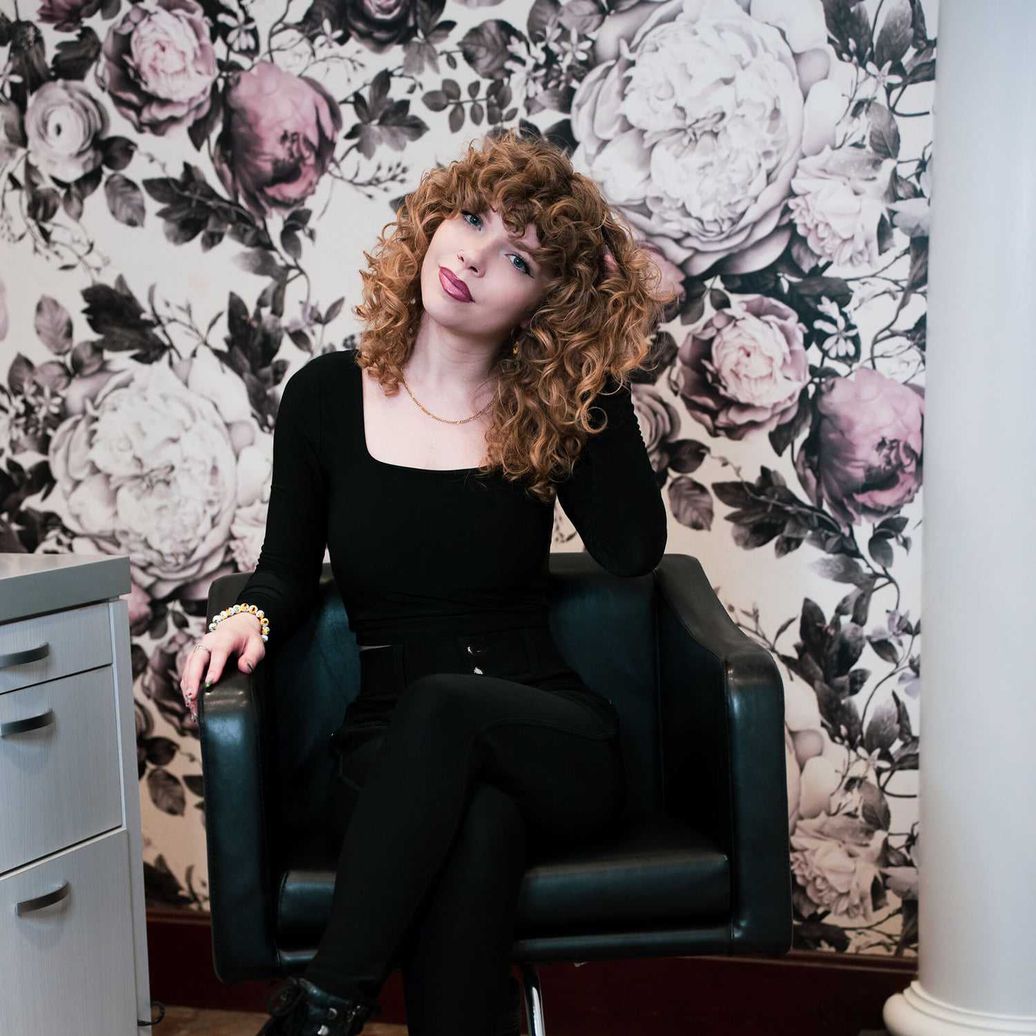 Portrait of Braelyn, a professional stylist at Above All Grand Salon and Spa, showcasing their expertise and style.