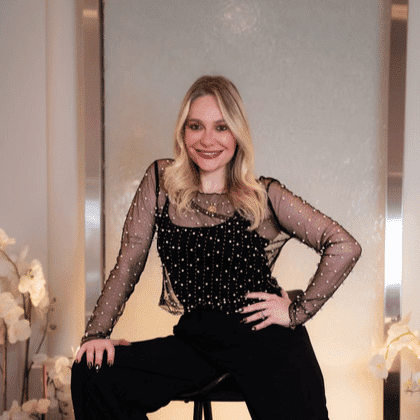 Portrait of Larissa, a professional stylist at Above All Grand Salon and Spa, showcasing their expertise and style.